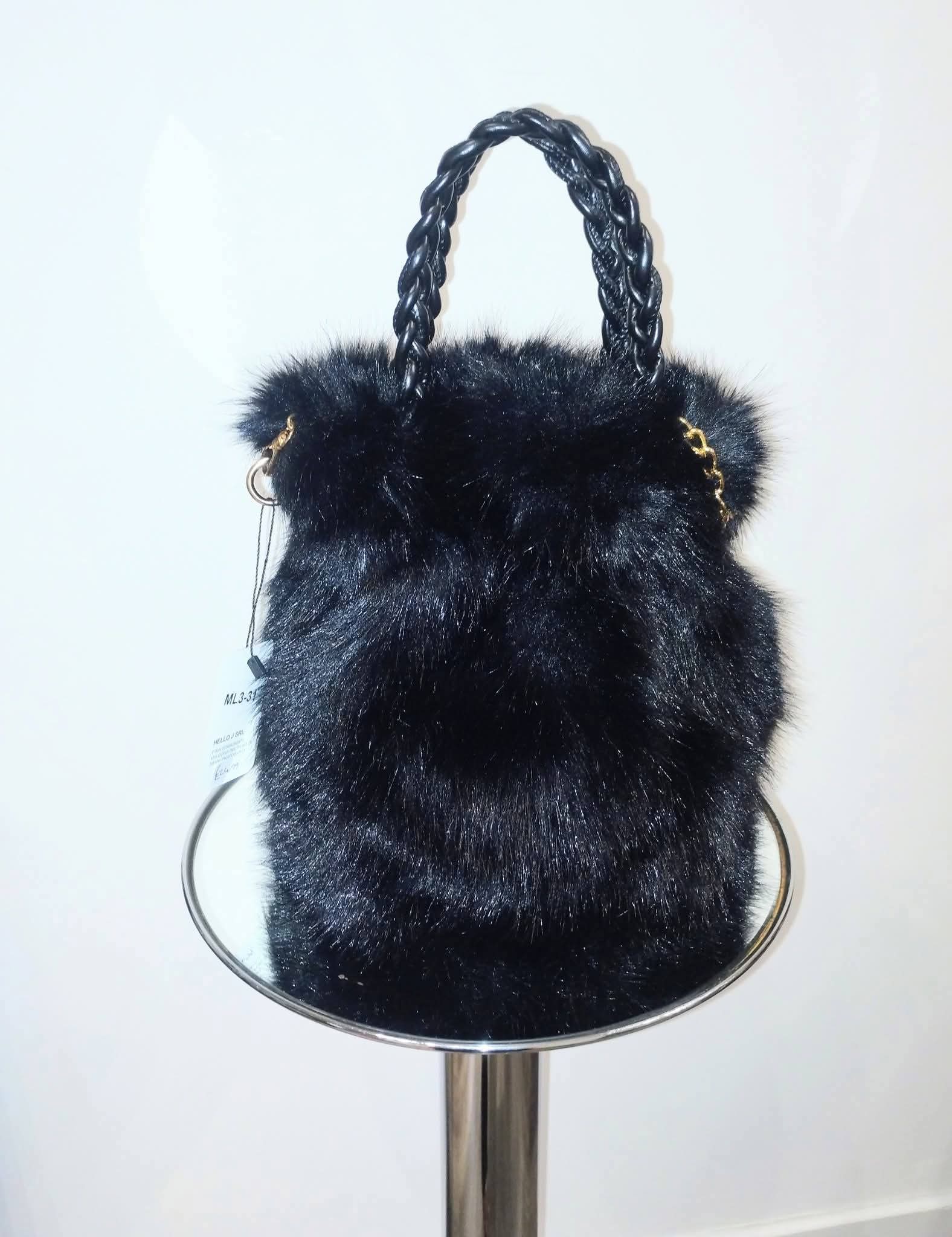 Black fur handbag with braided handle on a white background